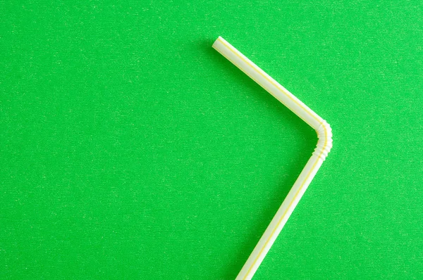 A drinking straw on a green background — Stock Photo, Image