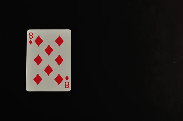 Jugando a cartas. Ocho de diamante aislado sobre fondo negro — Foto de Stock