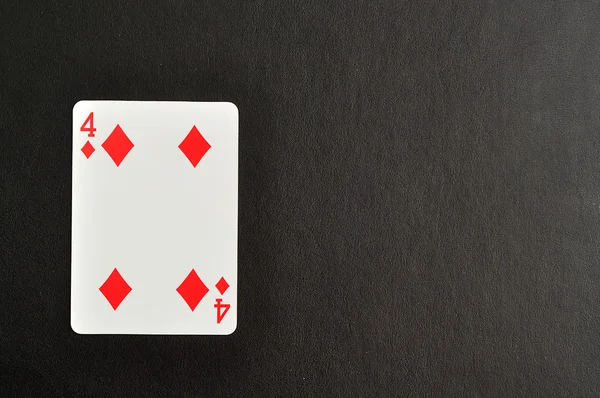 Гральна картка. Чотири алмази ізольовані на чорному тлі — стокове фото