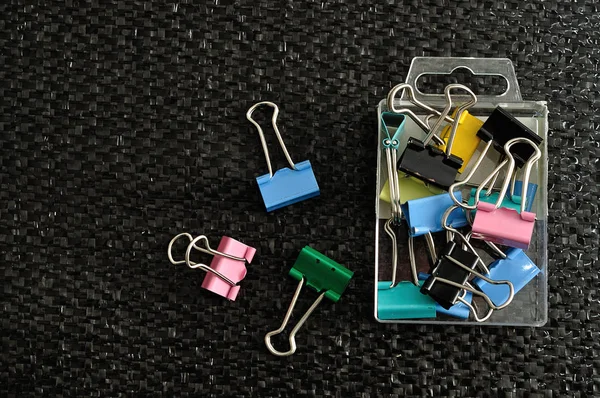 Colorful binder clips in a container — Stock Photo, Image