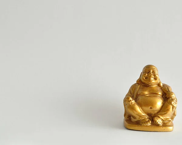 Figurine of a laughing and cheerful golden Buddha — Stock Photo, Image