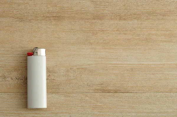 Біла запальничка ізольована на дерев'яному фоні — стокове фото