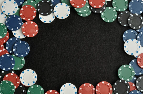 Siyah bir arka plan ile bir sınır oluşturan poker fişleri — Stok fotoğraf