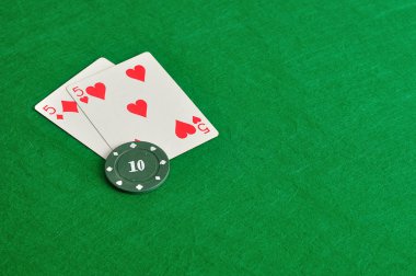 İki kart yeşil bir arka plan üzerinde poker chip ile
