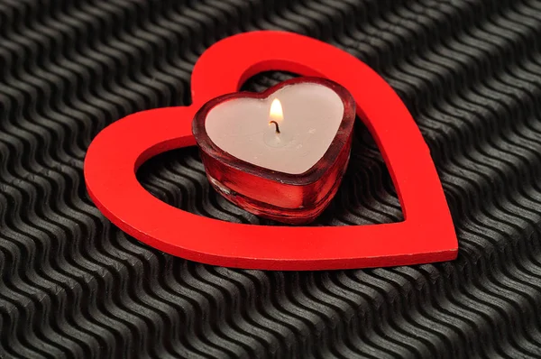 A heart shape candle with a red heart