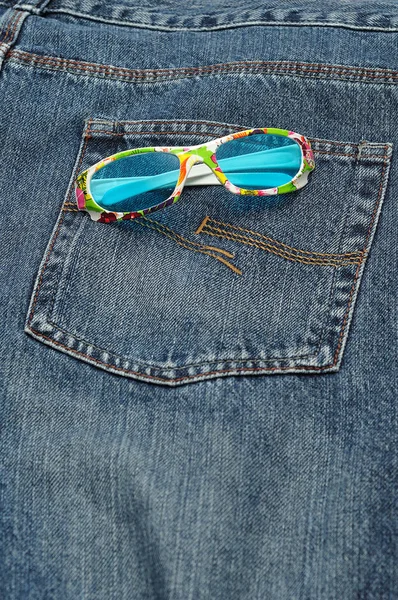 Барвиста пара сонцезахисних окулярів в задній кишені джинсового джинсу — стокове фото