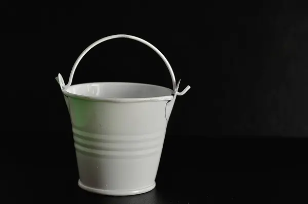 A white miniature bucket isolated on a black background — Stock Photo, Image