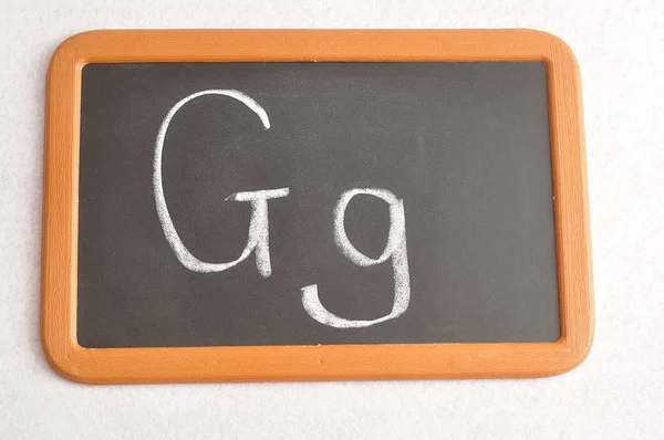 Czarny deska od litery G — Zdjęcie stockowe