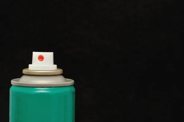 An aerosol can isolated against a black background — Stock Photo, Image