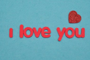 Ben kırmızı bir kalp ile mavi bir arka plan üzerinde kırmızı harflerle seviyorum