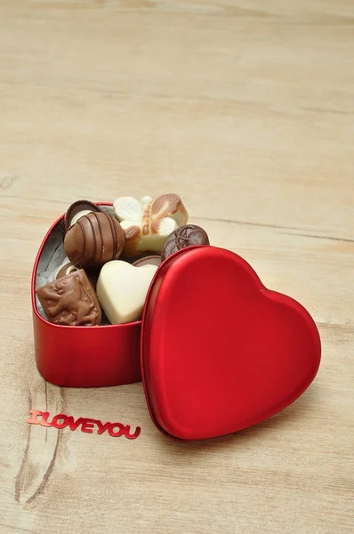 A heart shape tin filled with delicious small chocolates