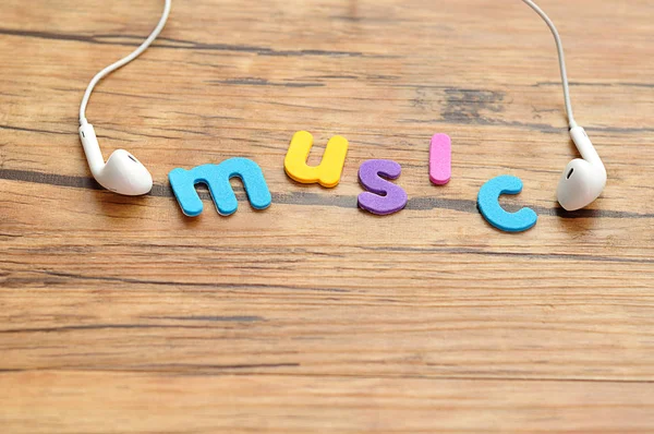 Auriculares blancos con la palabra música —  Fotos de Stock