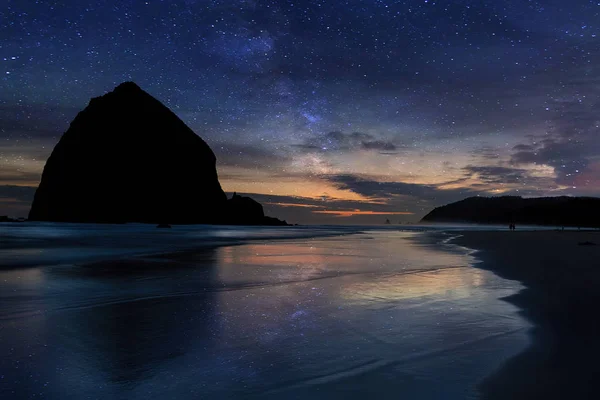 Oregon kıyılarında yıldızlı gece gökyüzünün altında Haystack Rock — Stok fotoğraf