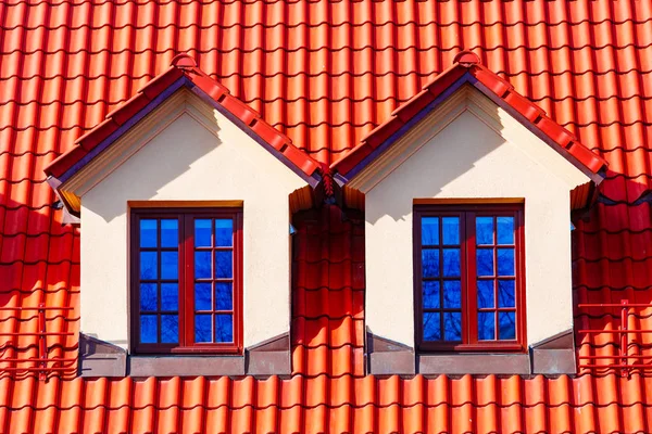 Two dormer windows on tiled roof, close up. Cottage concept