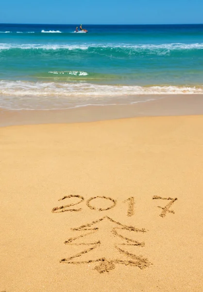Číslice 2017 a vánoční strom na pláži — Stock fotografie