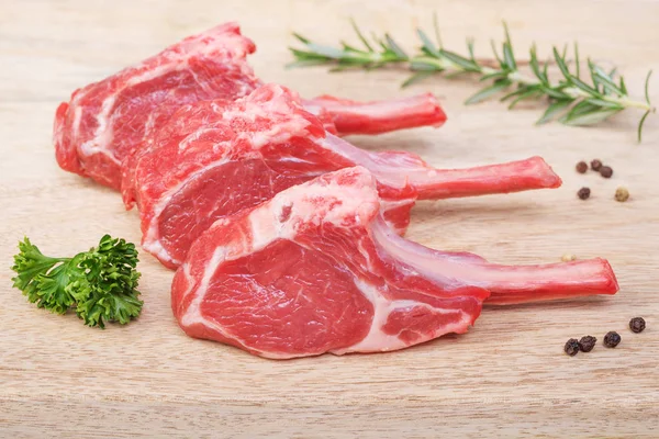 Fresh  lamb cutlet  on wooden  background — Stock Photo, Image