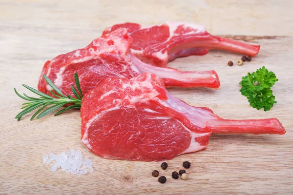 Fresh  lamb cutlet  on wooden  background — Stock Photo, Image