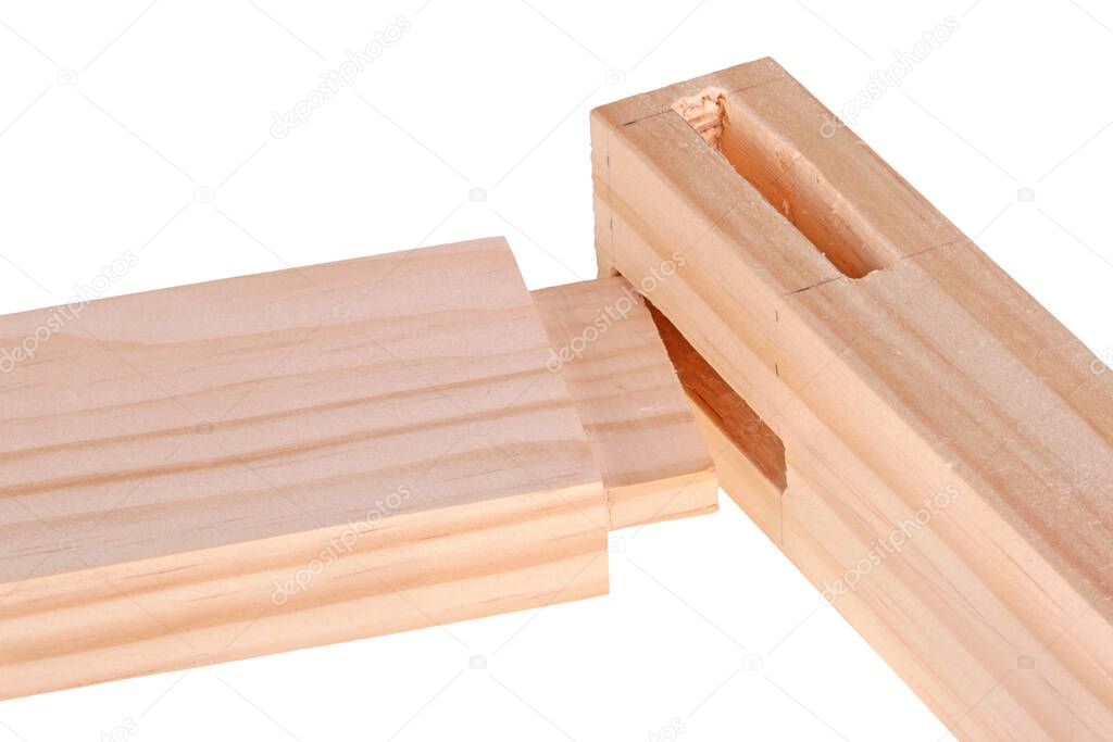 Close-up of the ends of pine boards with two freshly cut woodworking mortises and a tenon isolated against a white background
