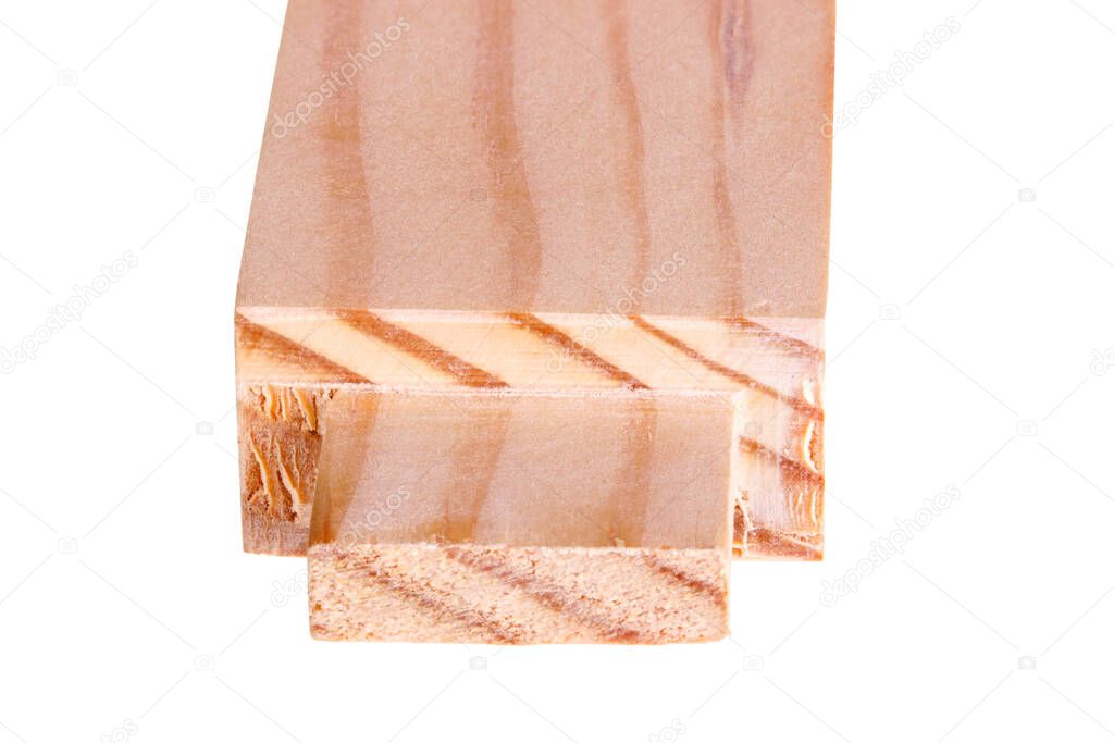 Close-up of the end of a pine board with a freshly cut woodworking tenon isolated against a white background