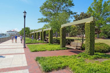 BEAUFORT, SOUTH CAROLINA - APRIL 16 2017: People enjoying the swings and promenade of the Henry C. Chambers Waterfront Park located south of Bay Street in the Historic District of downtown Beaufort