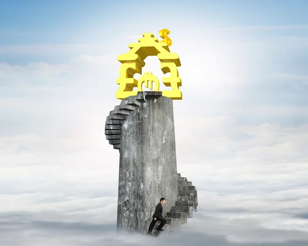 Man climbing stairs to money house on tower — Stock Photo, Image