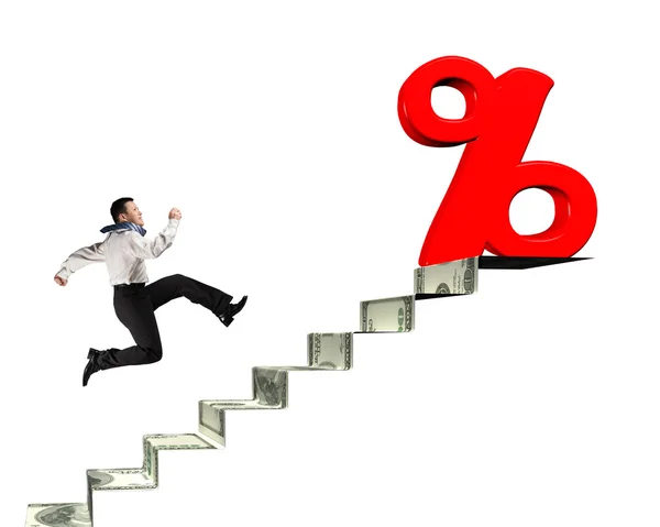 Man running toward percentage sign on top of money stairs — Stock Photo, Image