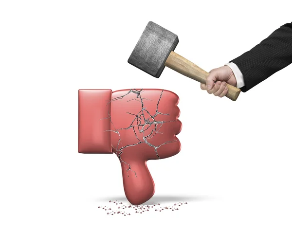 Hand holding hammer hitting red thumb down with cracks — Stock Photo, Image