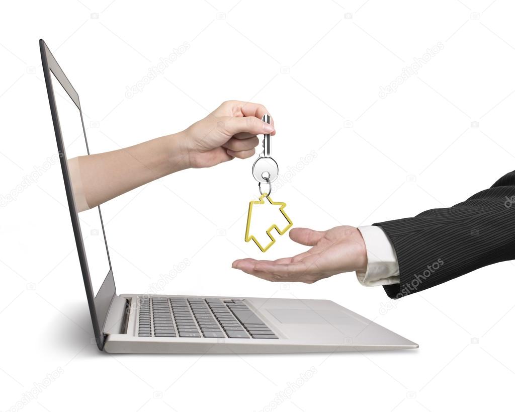 Woman hand from laptop giving house key to man hand