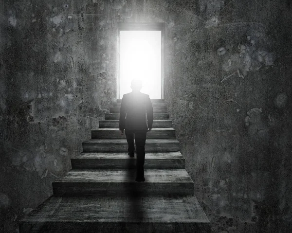 Man climbing concrete stairs toward door with bright light. — Stock Photo, Image