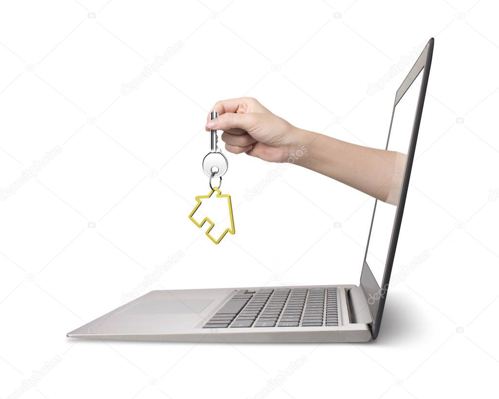 Hand holding house key comes from laptop screen