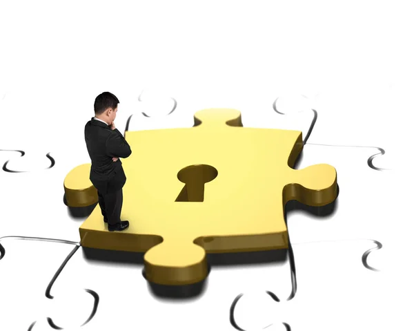 Man looking at golden puzzle piece with keyhole — Stock Photo, Image