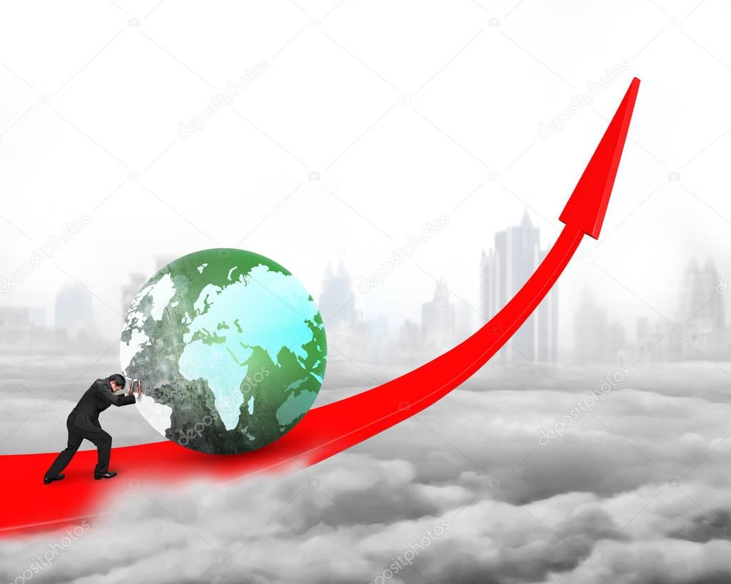 Businessman pushing globe upward on red trend line