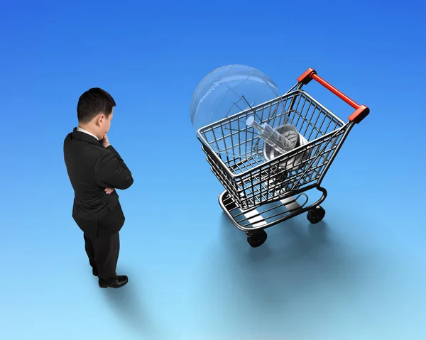 Man looking at shopping cart with light bulb top view — Stock Photo, Image