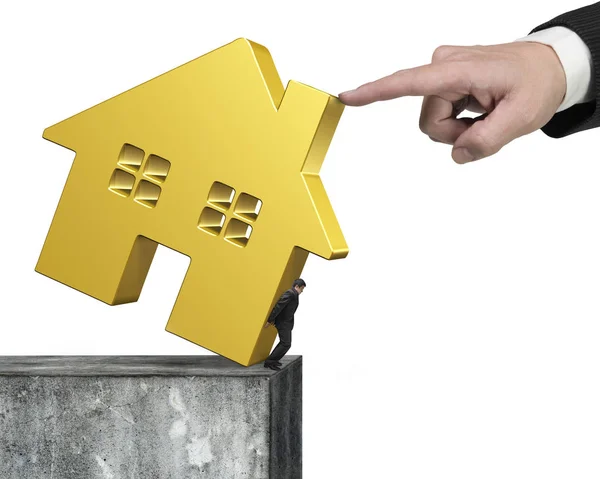 Man holding golden house on concrete wall with hand helping — Stock Photo, Image