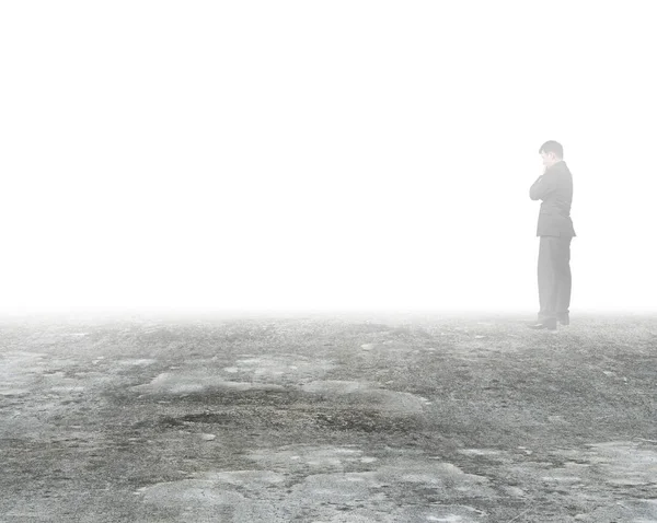 Man thinking and standing in mist on dirty concrete floor — Stock Photo, Image