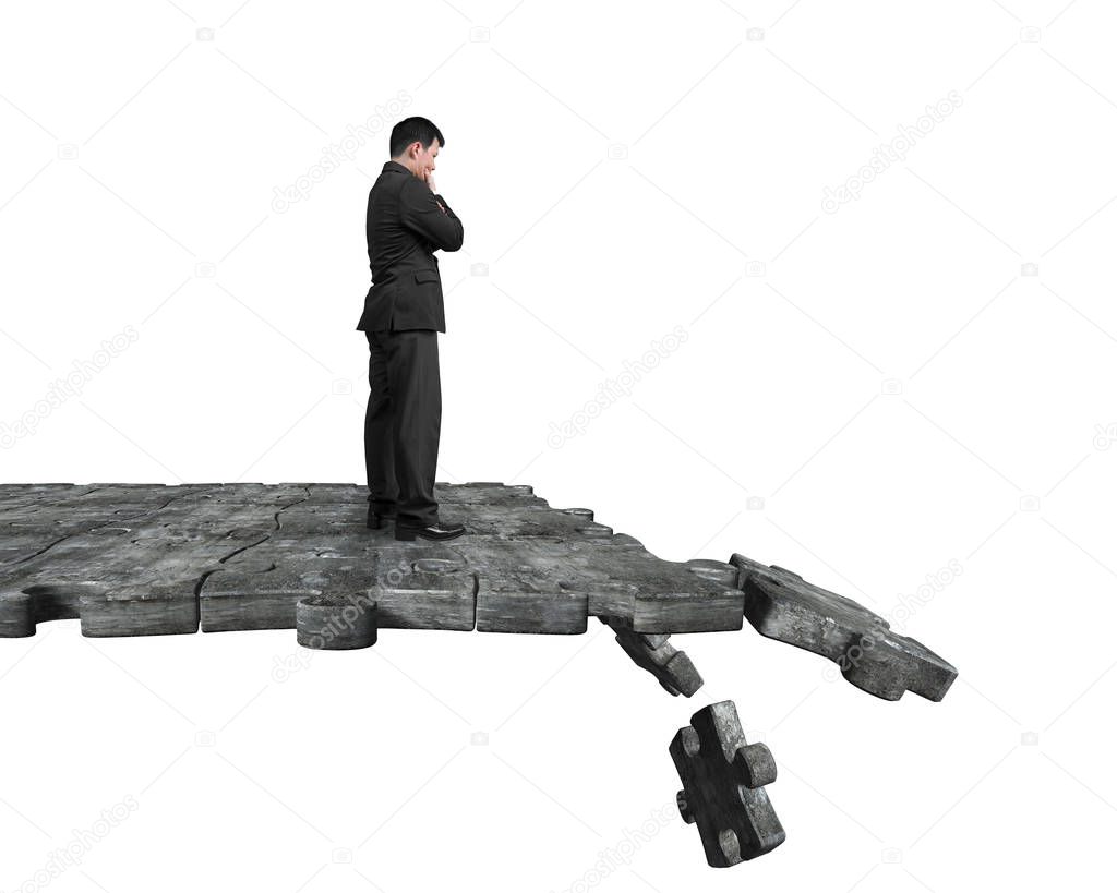 Thinking man standing on breaking puzzle ground