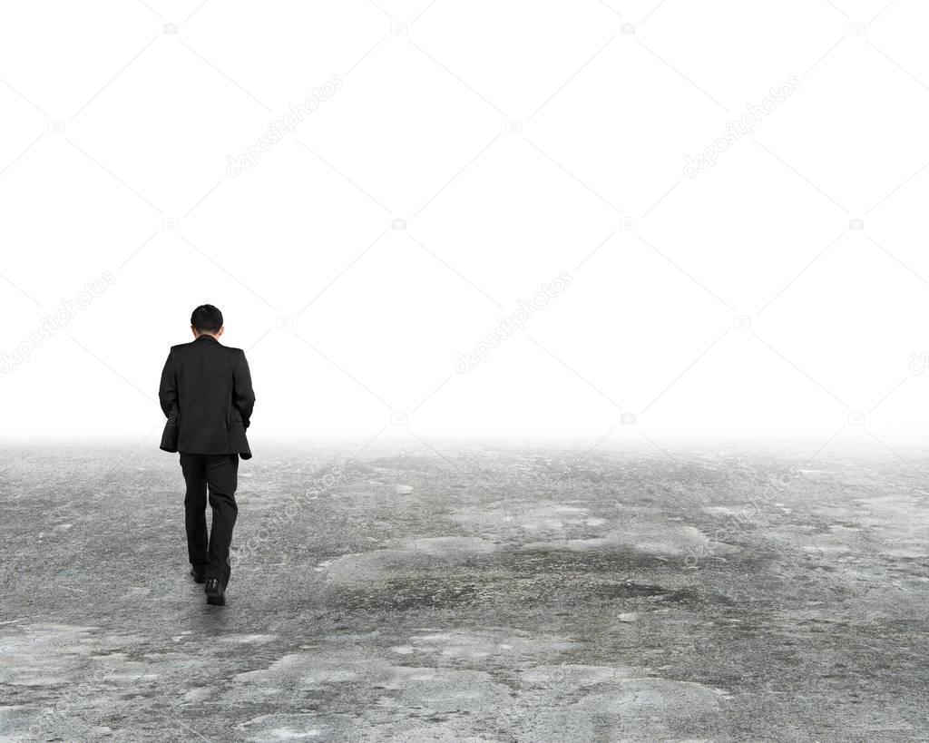 Man walking in mist on dirty concrete floor