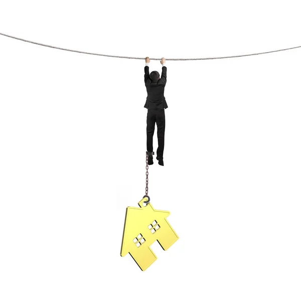 Businessman shackled by gold house hanging on rope — Stock Photo, Image