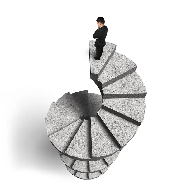 Empresário em pé na escada em espiral de concreto — Fotografia de Stock