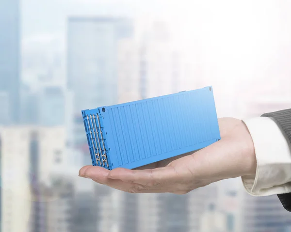 Human hand holding 3d blue cargo container — Stock Photo, Image