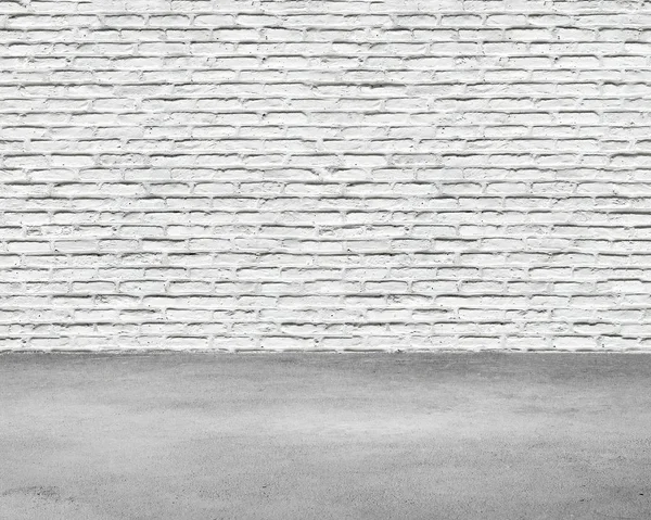 Room interior with white brick wall and concrete floor — Stock Photo, Image