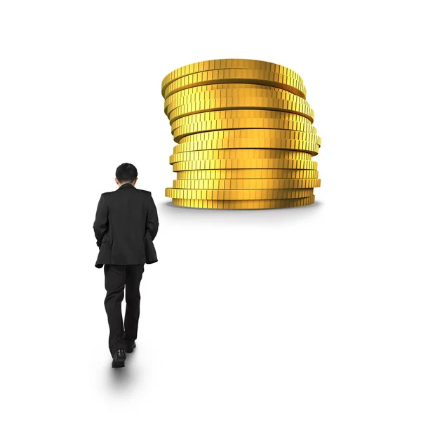 Businessman walking toward stack of golden coins — Stock Photo, Image