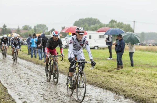 Group of Cyclists on a Cobblestone Road - Tour de France 2014 — Stock Photo, Image