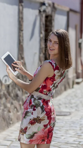 여자의 태블릿을 포장된 거리에서 너머로 — 스톡 사진