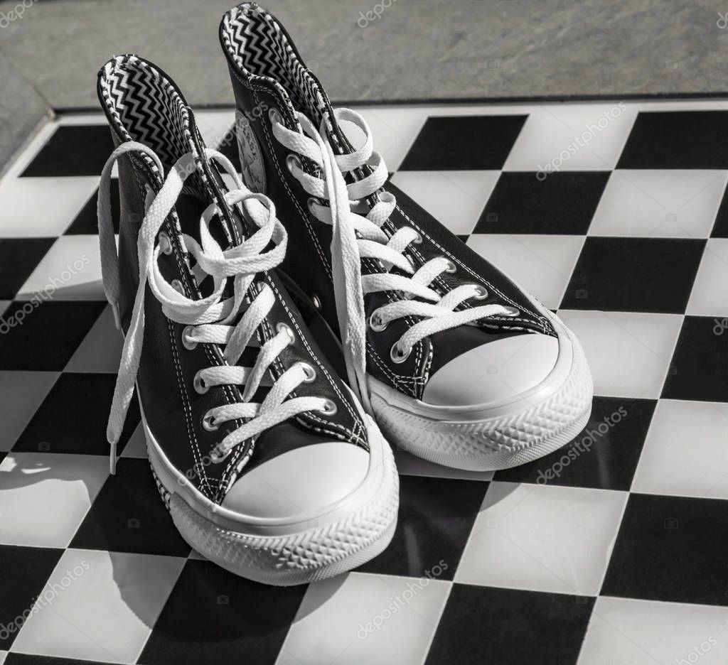 Chartres, France - Spetember 2, 2019: Image of a pair of All Star Converse sneakers on a cobblestone street.