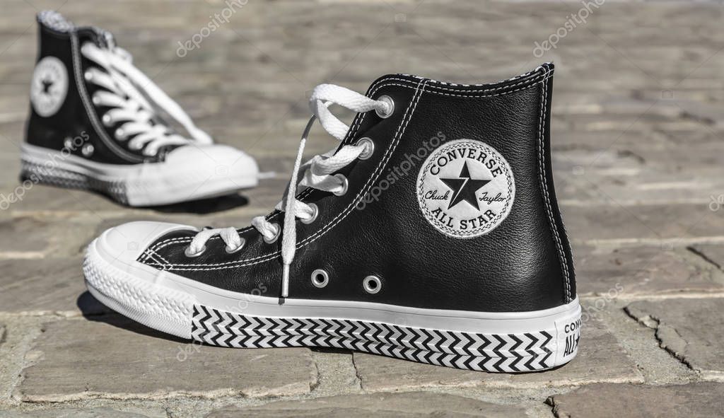 Chartres, France - Spetember 2, 2019: Image of a pair of All Star Converse sneakers on a cobblestone street.