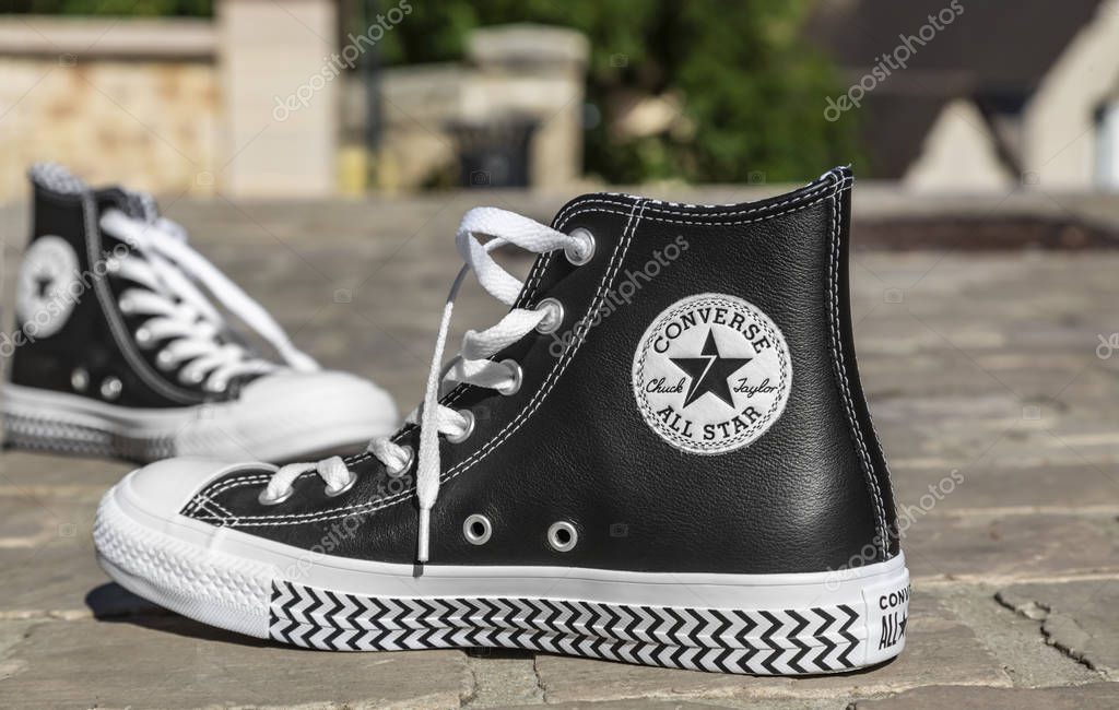 Chartres, France - Spetember 2, 2019: Image of a pair of All Star Converse sneakers on a cobblestone street.