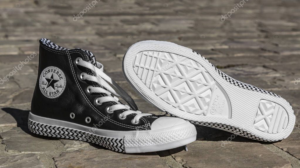 Chartres, France - Spetember 2, 2019: Image of a pair of All Star Converse sneakers on a cobblestone street.
