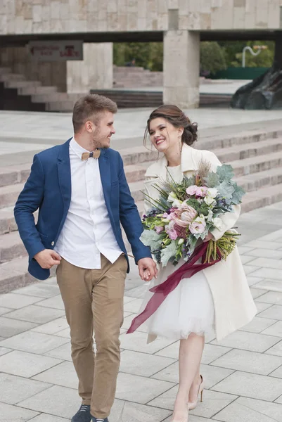 Just married loving couple in wedding dress and suit . Happy bride and groom walking running in the summer city. Romantic Married young family — Stock Photo, Image