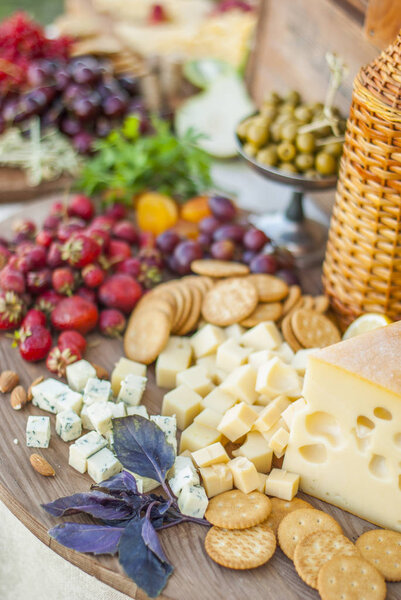 Cheese and fruits on a beautifully vintage decorated table